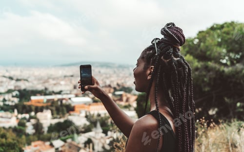 Preview: Black girl is taking photo outdoors