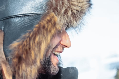 Preview: bearded man in a big winter hat laughing