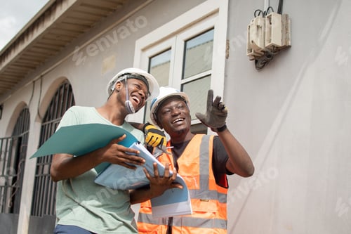 Preview: two people in safety vests and hard hats looking at blue folder
