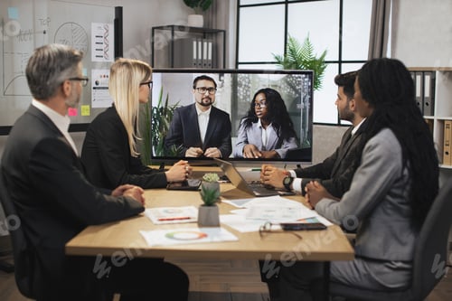 Preview: Caucasian business man and African woman tells business program to their multinational colleagues