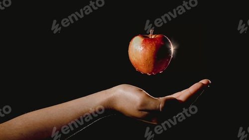 Preview: Hand holding an apple suspended in the air
