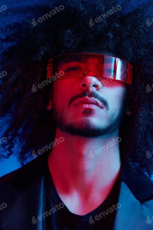 Preview: Fashion portrait of a man with curly hair on a blue background wearing red sunglasses, multinational