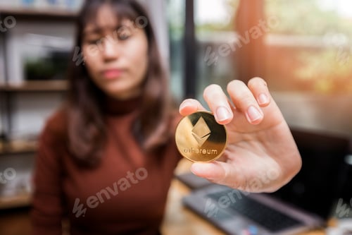 Preview: Golden Ethereum (cryptocurrency) in hand of businesswoman. New Virtual money concept