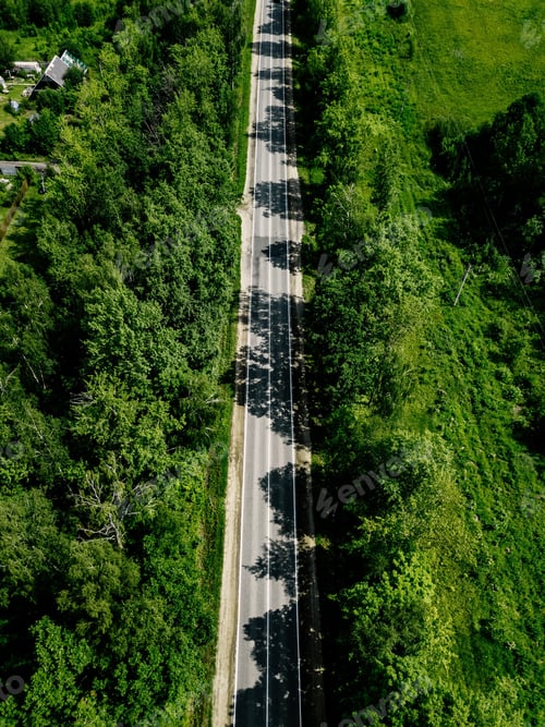 Preview: Aerial view of road through the green forest in rural country