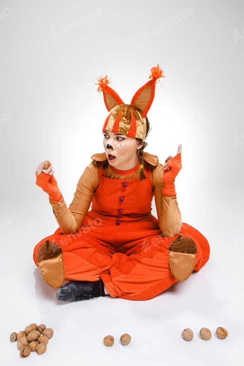 Preview: Young Woman In The Image Of Red Squirrel With Walnuts