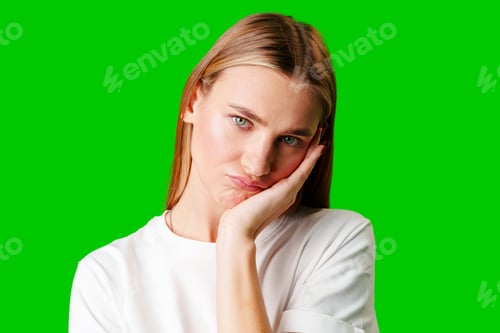 Preview: Young Woman With Pursed Lips Expressing Skepticism Against Green Screen Background