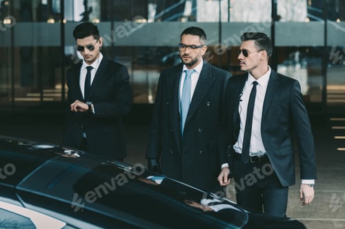 Preview: two bodyguards going with businessman to black car