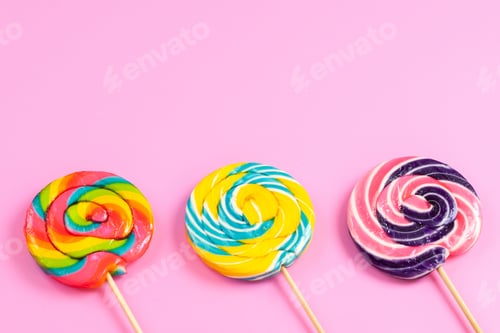 Preview: a front closed up view colorful lollipops sweet round shaped on the little sticks isolated on the