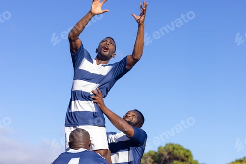 Preview: Three African American young male athletes training on field, playing rugby, copy space