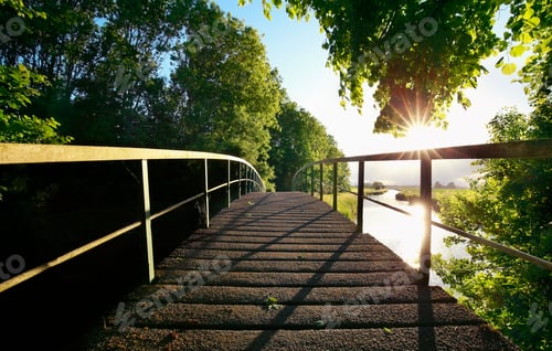 Preview: wooden bridge via river on sunny day