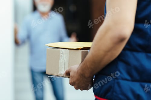 Preview: Close-up of unrecognizable courier making home delivery.