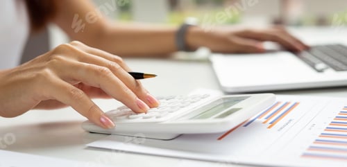 Preview: Asian female finance staff is pressing a calculator to calculate company sales and profit to report