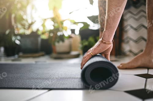Preview: Man Rolling Out a Yoga Mat at Home