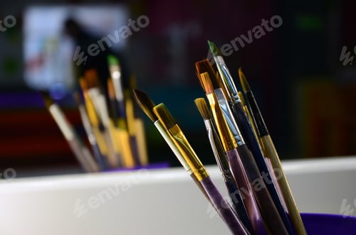 Preview: Art paint brushes in cup are located in the children's entertainment hall at the mirror