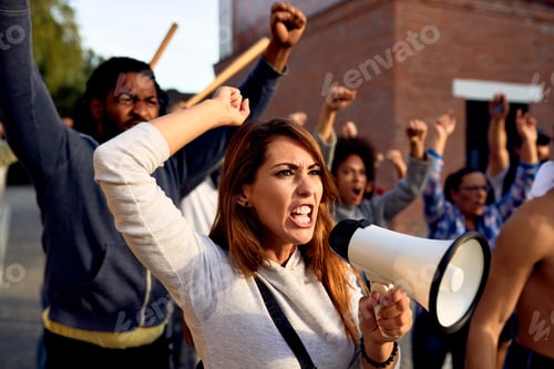 Preview: Angry woman shouting through megaphone during public demonstrations.