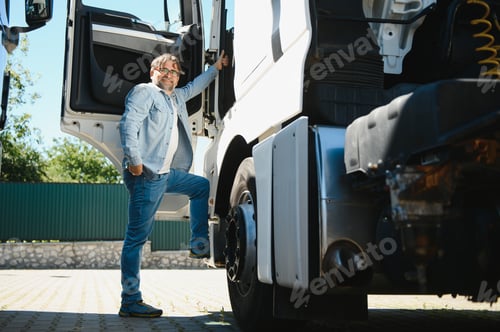 Preview: Portrait of bearded trucker standing by his truck vehicle. Transportation service. Truck driver job