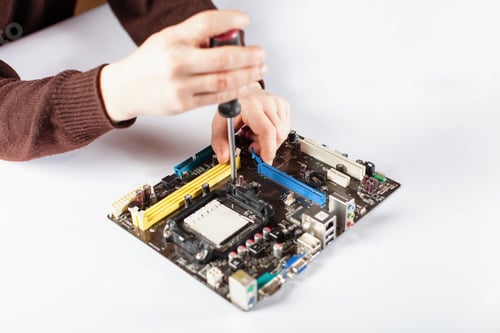 Preview: Technological background with closeup on tester checking motherboard