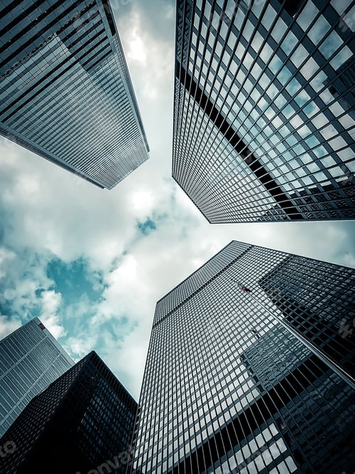Preview: Low-angle vertical shot of the modern skyscrapers against the sky
