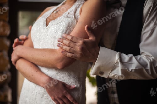 Preview: groom gently embraces the bride