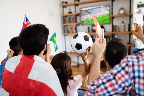 Preview: Soccer fans emotionally watching game in the living room.