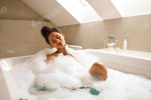 Preview: A young woman is happily bathing in a bathtub