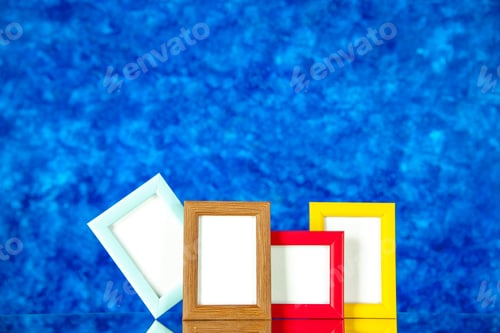 Preview: front view different picture frames with colored corners on blue background present family photo