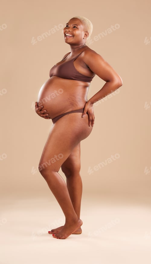 Preview: Black woman, laughing or holding pregnant stomach on studio background in body empowerment, love or