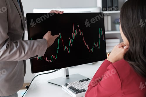 Preview: Close up view of young business team analyzing the stock market trend, focusing on computer monitor.