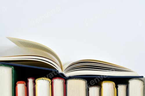 Preview: Row of colorful hardback books creating a border, read, reading, literacy, education, learning