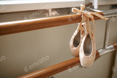 Preview: Pink ballet shoe hanging on barre, nobody