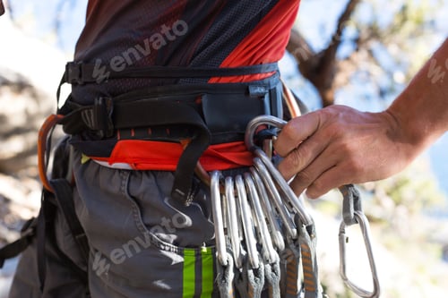 Preview: Climbing equipment on a male climber: rock shoes, rope, quickdraw, safety device