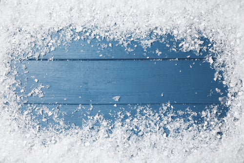 Preview: Frame of white snow on blue wooden background, top view with space for text. Christmas season