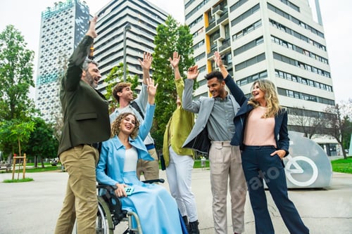 Preview: Diverse business team celebrating success in urban environment