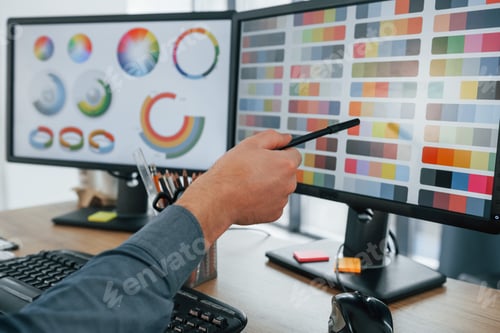 Preview: Using different colors. Male designer working in the office by using PC