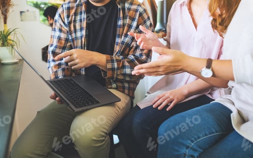 Preview: A group of business people using laptop computer while working together