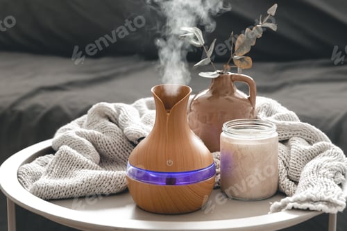 Preview: Spa composition with aroma oil diffuser lamp and candle on a blurred background.