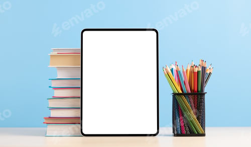 Preview: Tablet with colorful pencils and stack of books