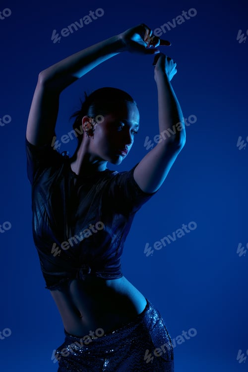 Preview: Stylish young woman showcasing unique fashion poses in modern studio setting
