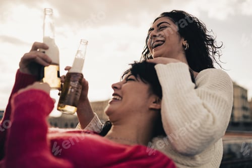 Preview: Girlfriends drinking beers outdoors