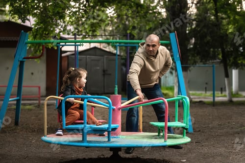 Preview: family having fun on the playground on a swing