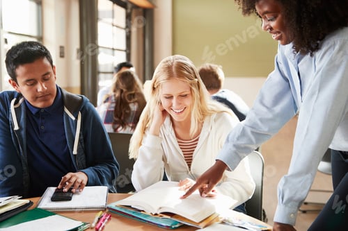 Preview: Group Of High School Students With Female Teacher Working At Desk