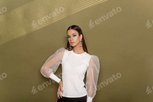 Preview: Khaki texture background with light shadow pattern. Close-up beauty portrait of girl with clean skin