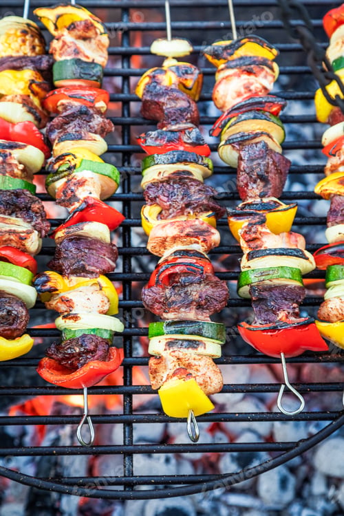 Preview: Closeup of hot skewers with meat on hot grill