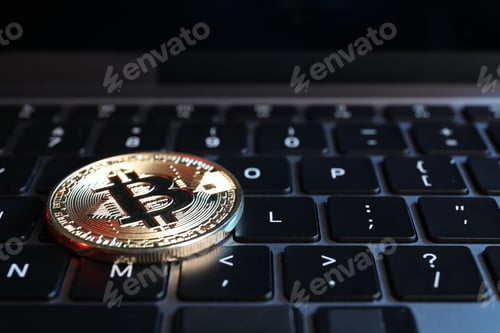 Preview: Cryptocurrency. Bitcoin on laptop keyboard, closeup view