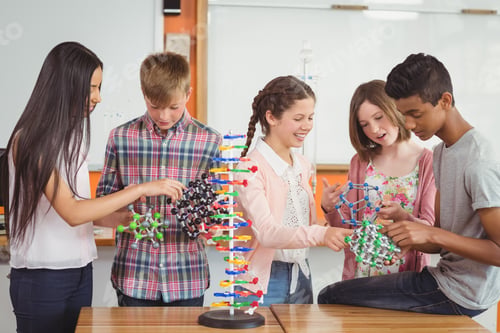 Preview: Happy school kids experimenting molecule model in laboratory