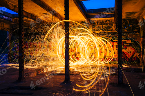 Preview: Circular golden spark light trails in derelict building