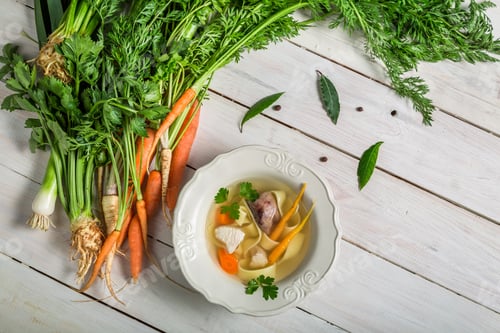 Preview: Homemade broth with noodles and ingredients on wooden table