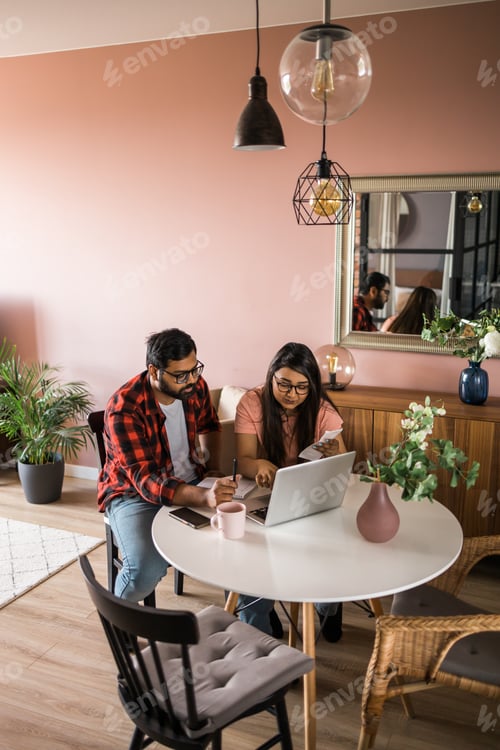 Preview: Serious wife and husband planning budget, checking finances, focused young woman using online