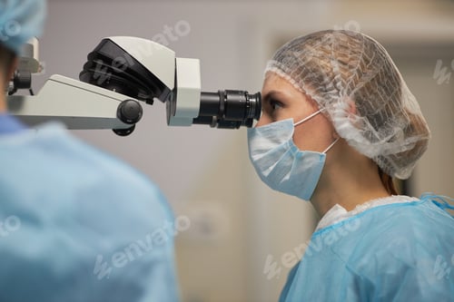 Preview: Woman Using Surgical Microscope during Medical Procedure