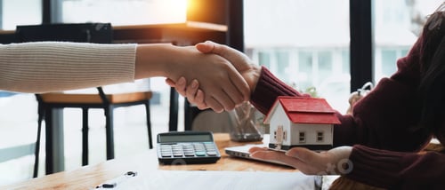 Preview: Real estate agents and customers shake hands to congratulate on signing a contract to buy a house